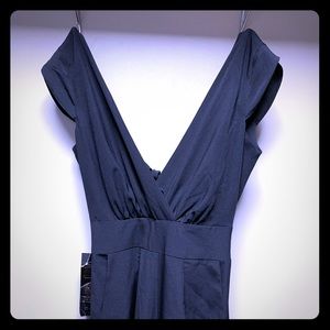 Black body pant suit , deep v-neck , drop back.